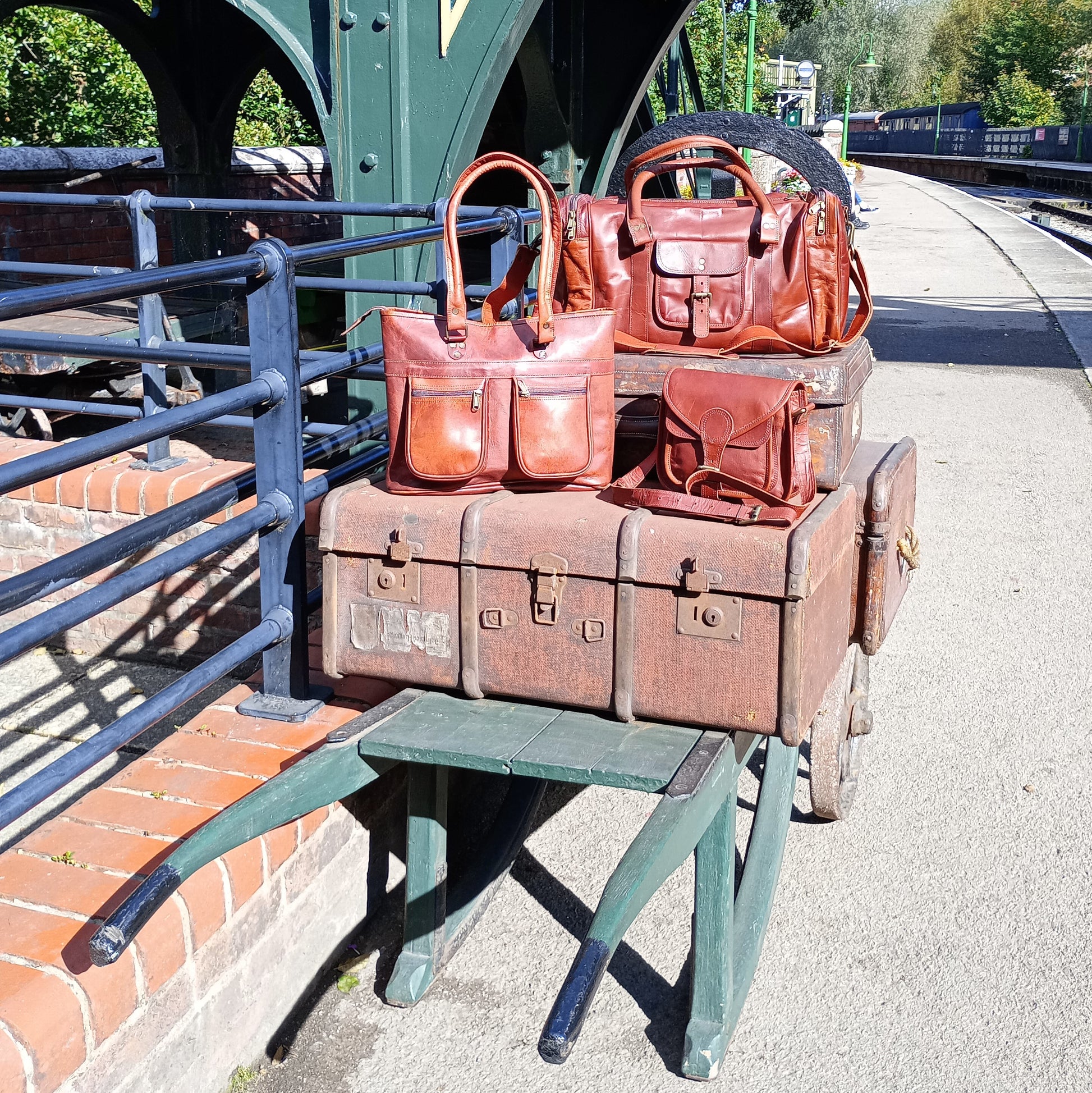 a smart collection of leather bags, of which one is the leather holdall. Sat atop an old wooden platform trolley in the sunshine at Pickering Station.
