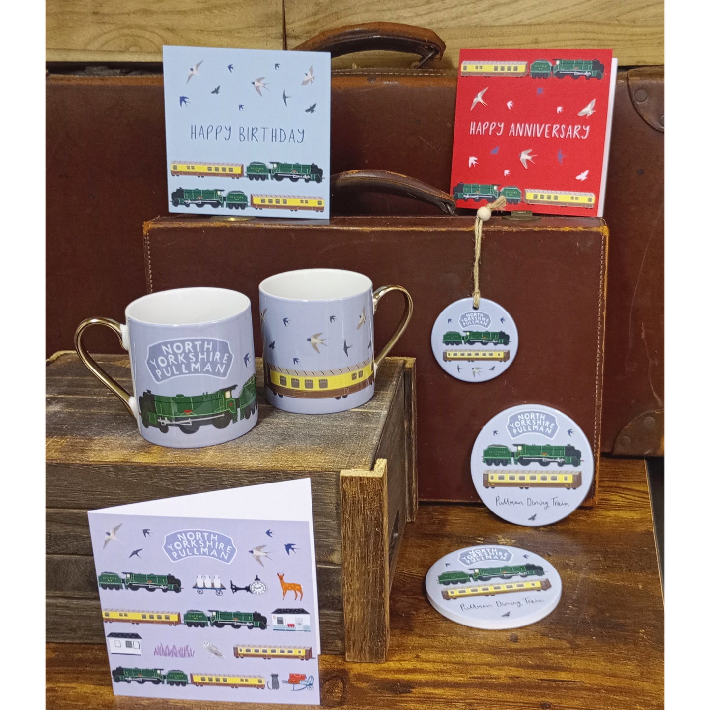 Group shot of several items in the range. All feature the locomotive Repton, and the dining carriages. Range includes cards, mugs, coasters and handing decorations