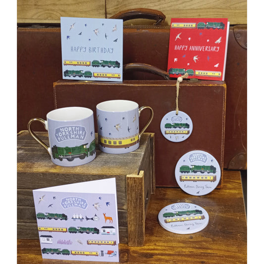 Group shot of several items in the range. All feature the locomotive Repton, and the dining carriages. Range includes cards, mugs, coasters and handing decorations