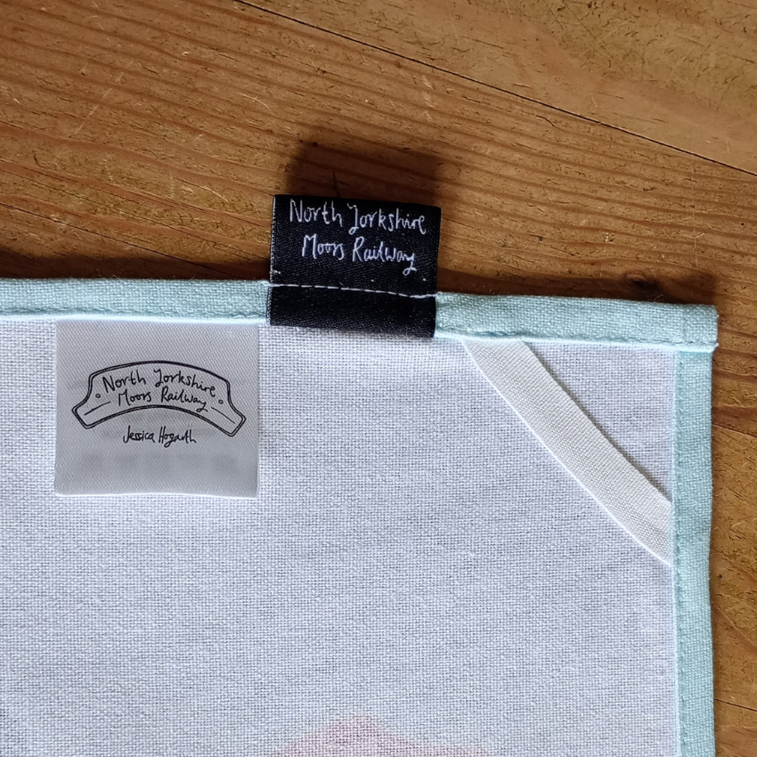 Light blue fabric with a label on a wooden surface