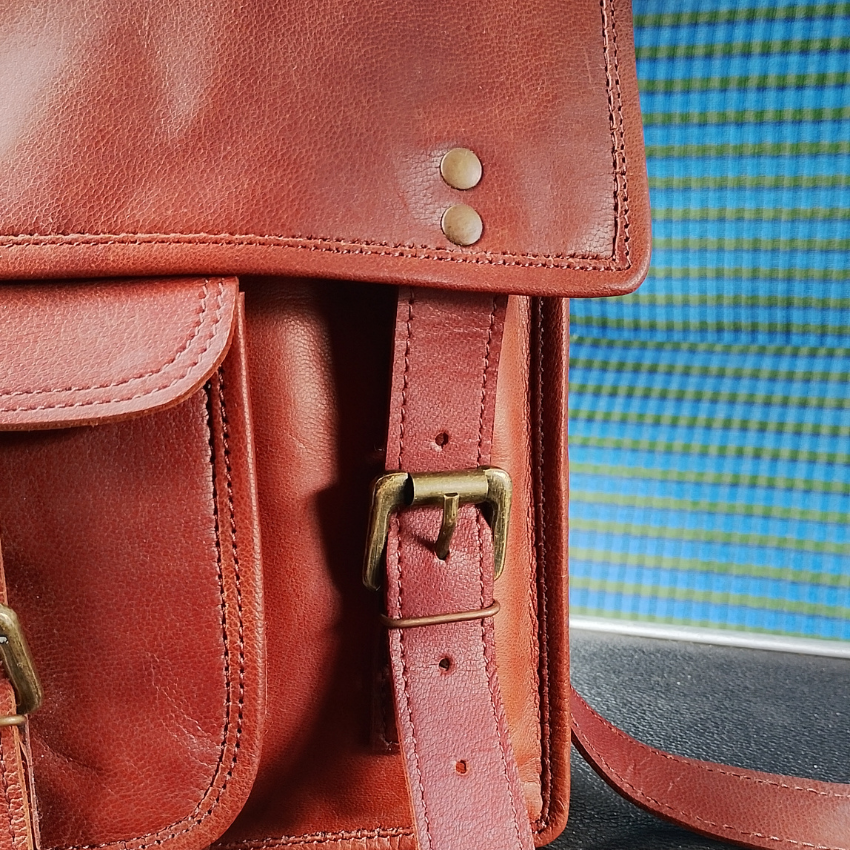 A close up of the satchel, showing stitching and riveting details