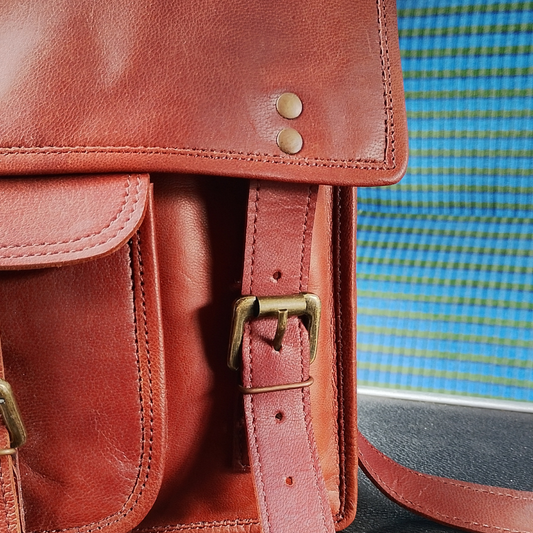 A close up of the satchel, showing stitching and riveting details