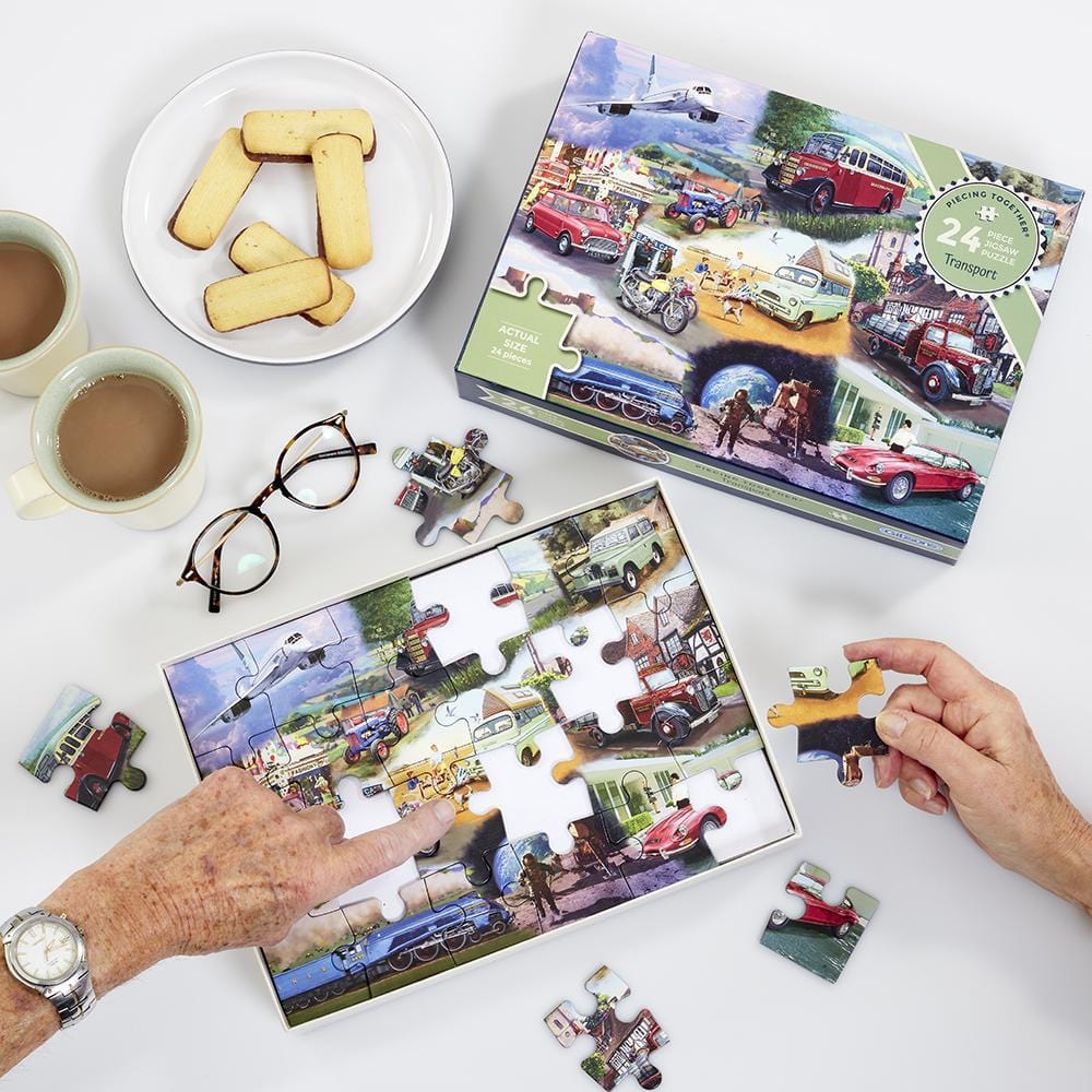 An image showing the jigsaw being put together, with hands to show the scale of the large pieces.
