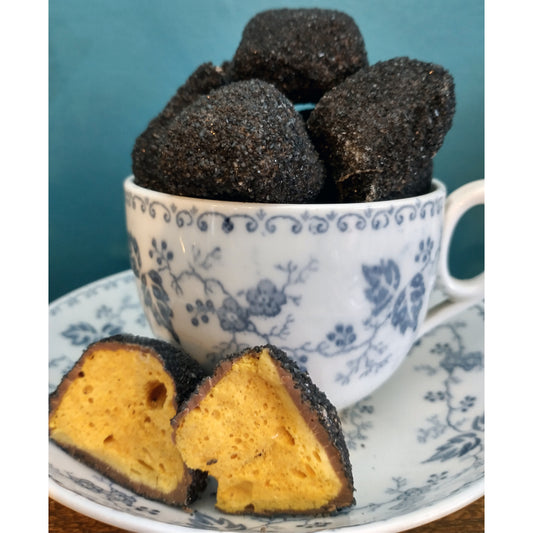 A picture showing the loose lumps of chocolate coal in a teacup and saucer.