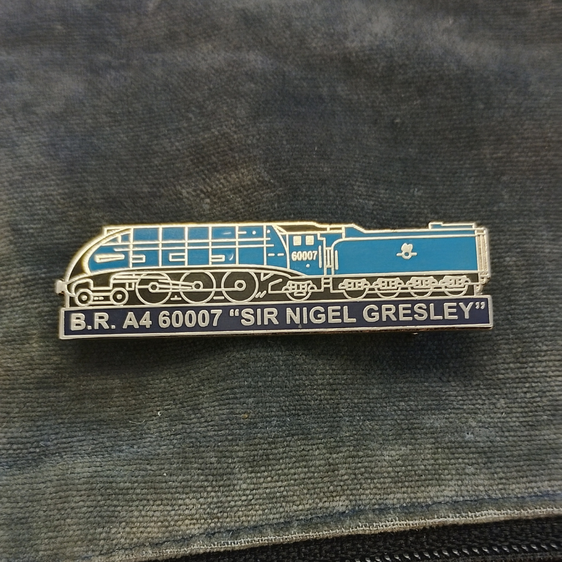 A blue and silver enamel pin shaped like an A4 locomotive with the text 'B.R. A 60007 Sir Nigel Gresley'