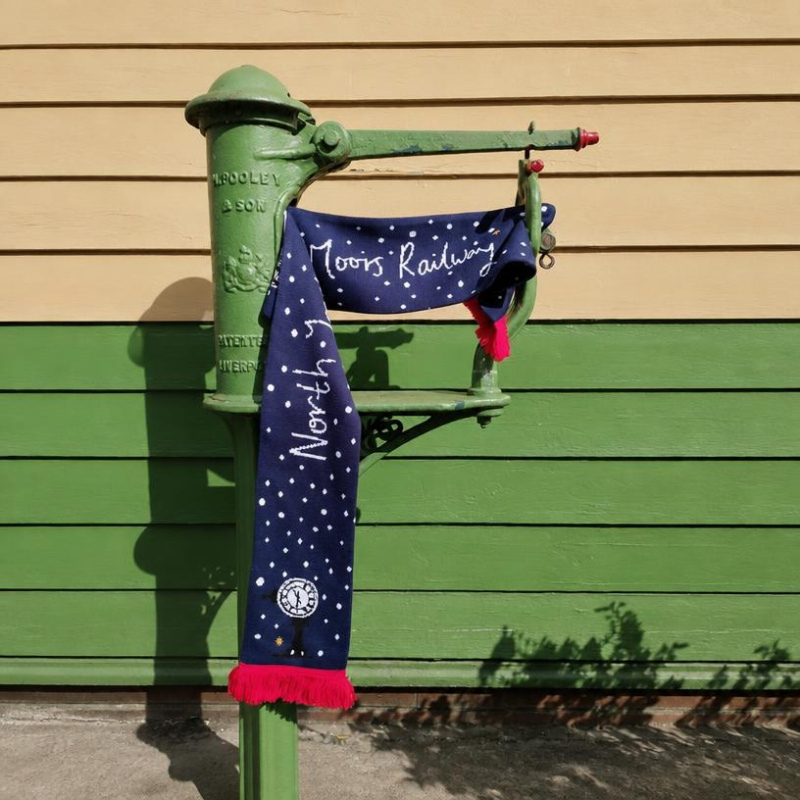 The scarf draped over the station weighing scales showing the reverse of the design.
