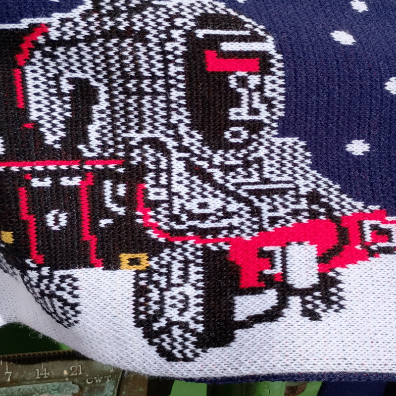Close up shot of the detail of the locomotive design which is knitted into the scarf.