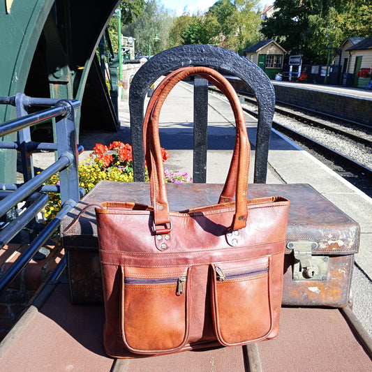 A gorgeous chestnut coloured leather tote with nice chunky handles, sunning itself on the Station Platform at Pickering.