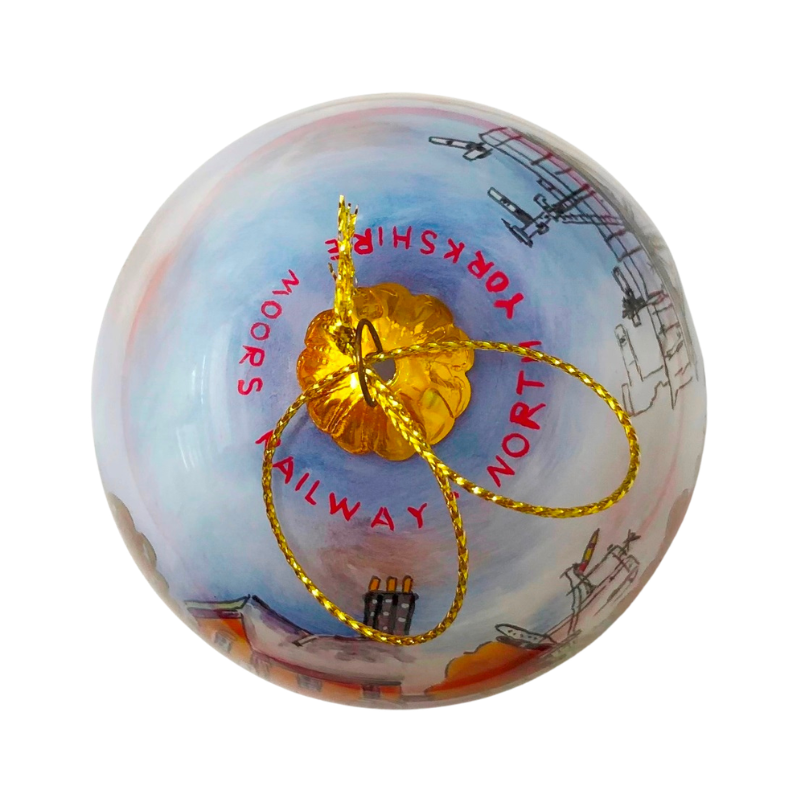 Bauble top view showing the writing NORTH YORKSHIRE MOORS RAILWAY around the top in red hand painted lettering.