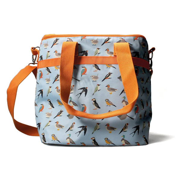 Pale blue bag with contrasting orange straps and a repeat pattern of bird illustrations all over. There is a long shoulder strap, and two shorter carry handles.
