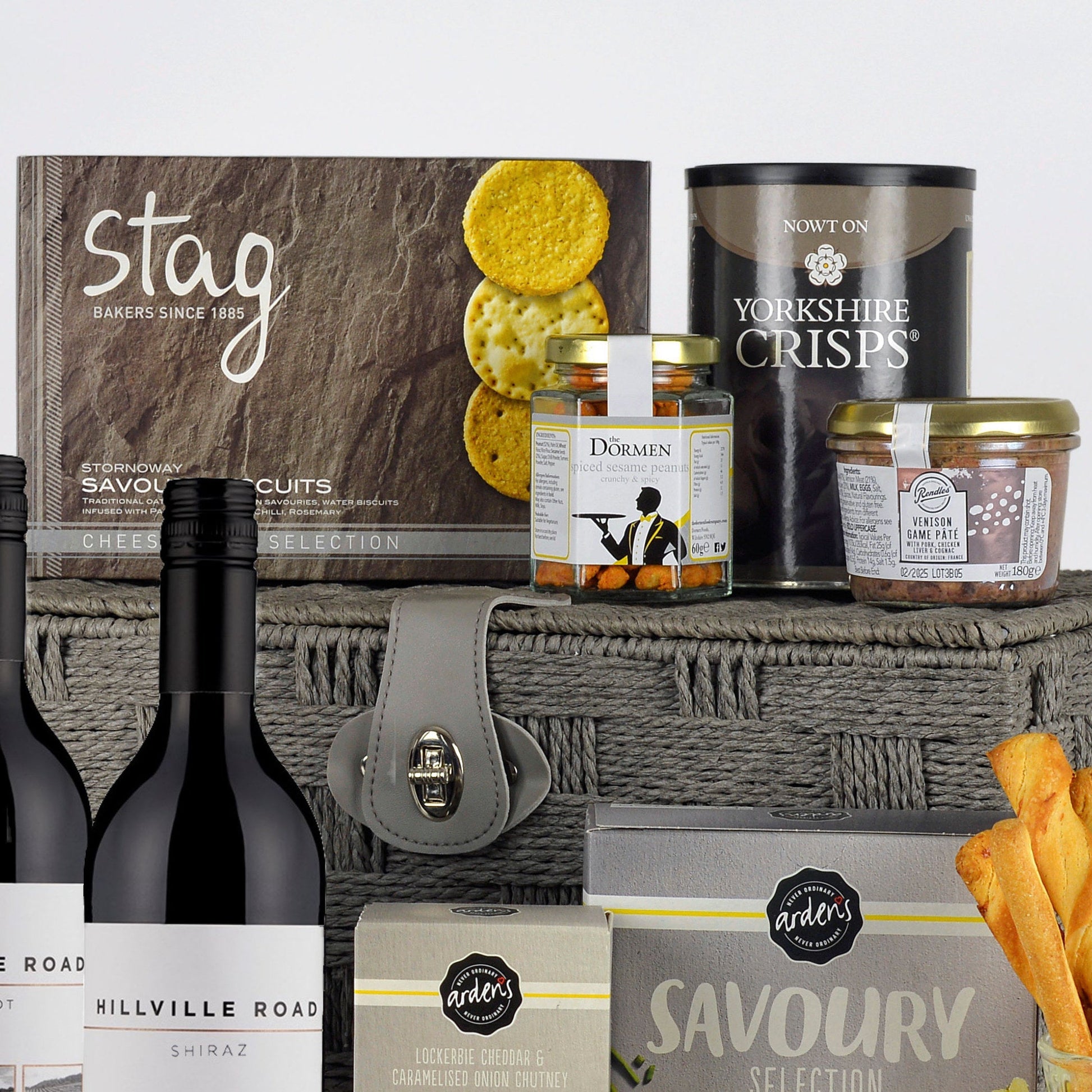 Assorted food products including bottles, jars, and a basket on a light gray background