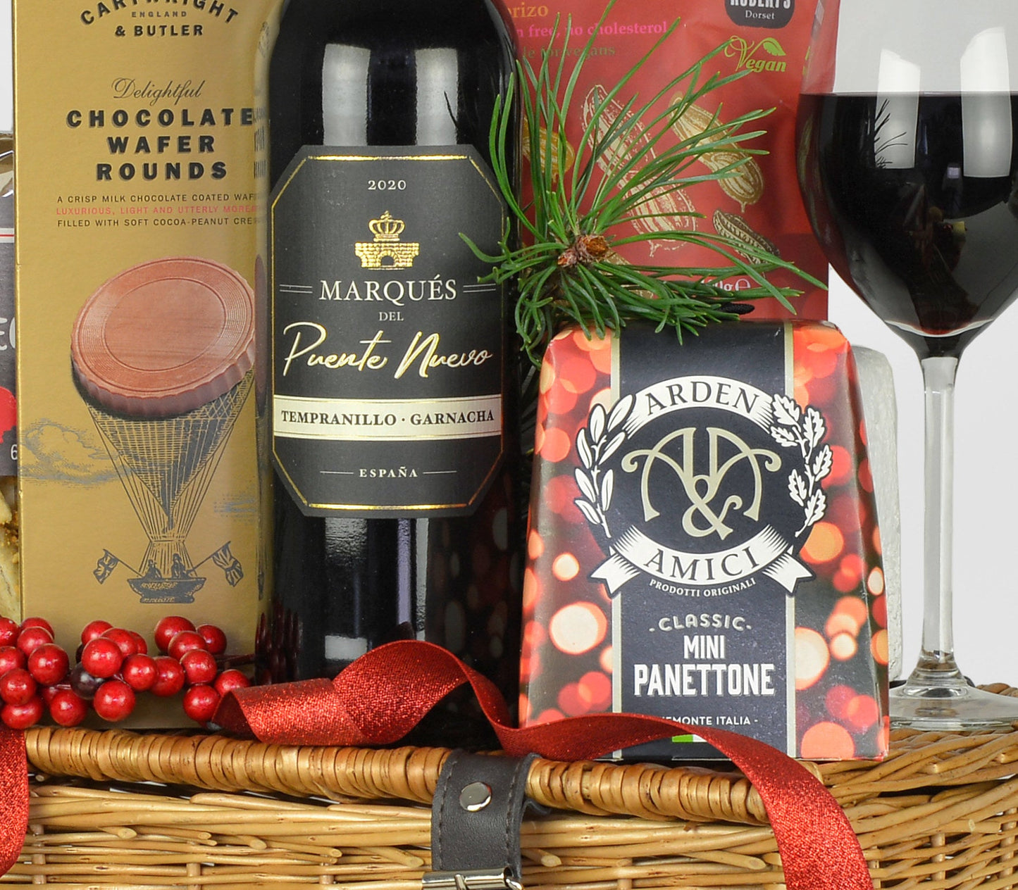 Wine gift basket with Marques del Puerto Nuevo wine, Arden Amici Panettone, and chocolate wafer rounds.