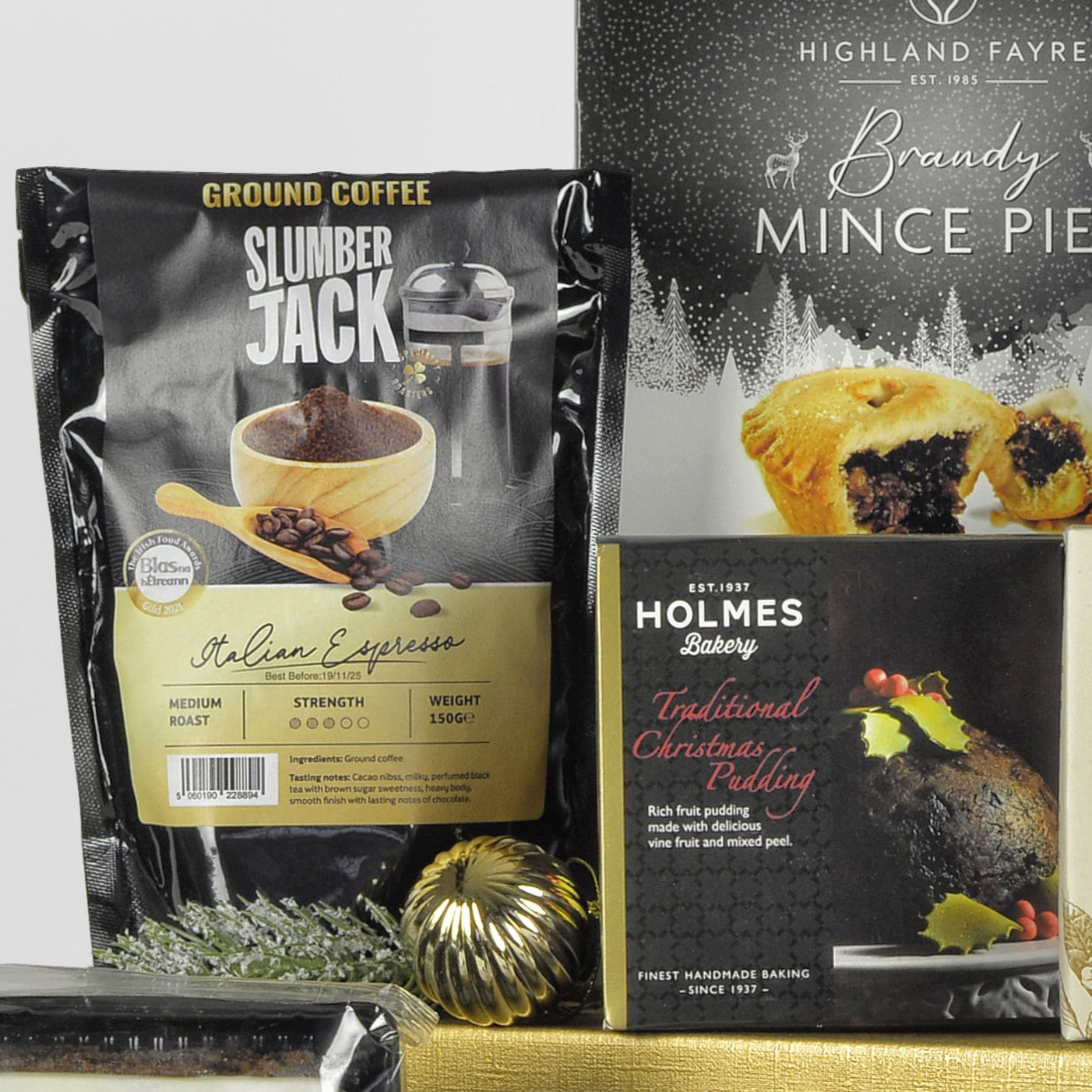 Packages of Slumber Jack coffee and Holmes Bakery Christmas pudding on a white background