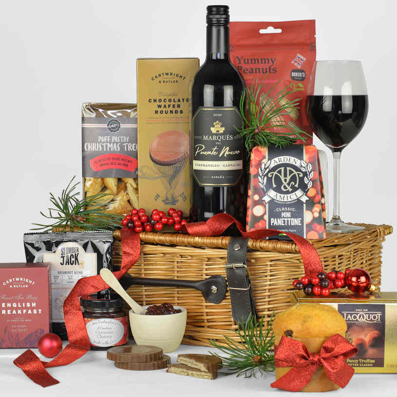 Christmas Eve Gift Basket with red wine, Christmas panettone, chocolates, tea, coffee and other tasty snack food items