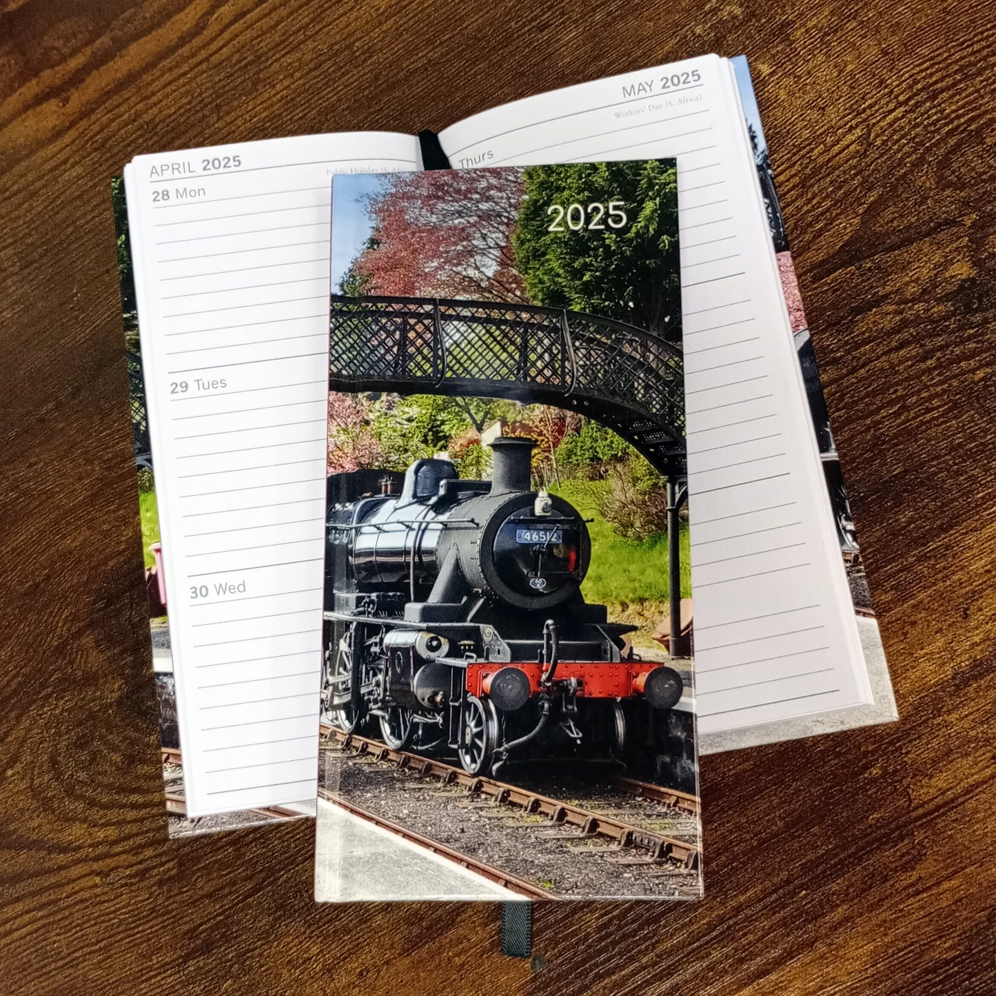 A slim pocket size diary with the locomotive 46512 on the front. Shown here with another copy of the diary open with the pages on display. MonWed on the left hand side and Thur-Sun on the right hand side.