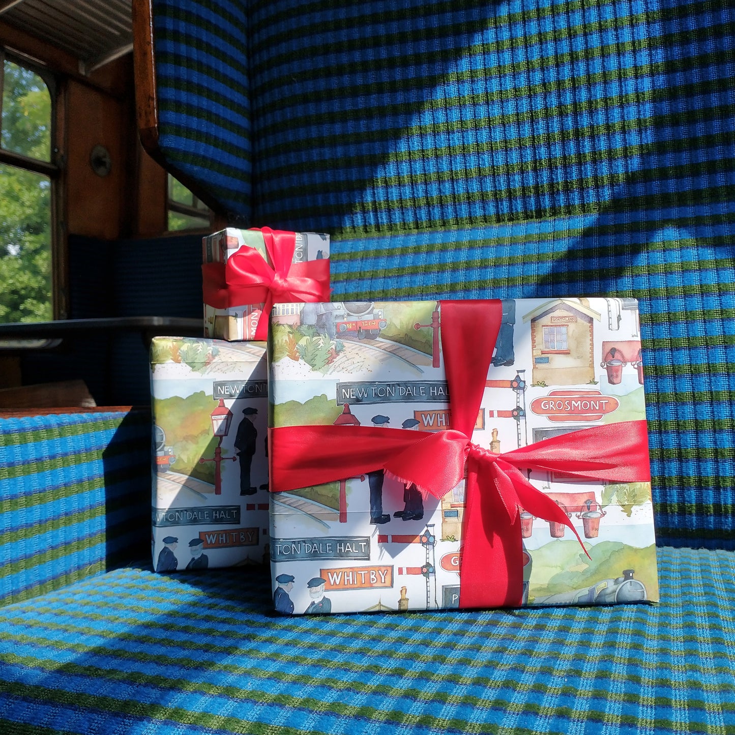 Parcels wrapped in Emma Ball wrapping paper sat on a carriage seat.