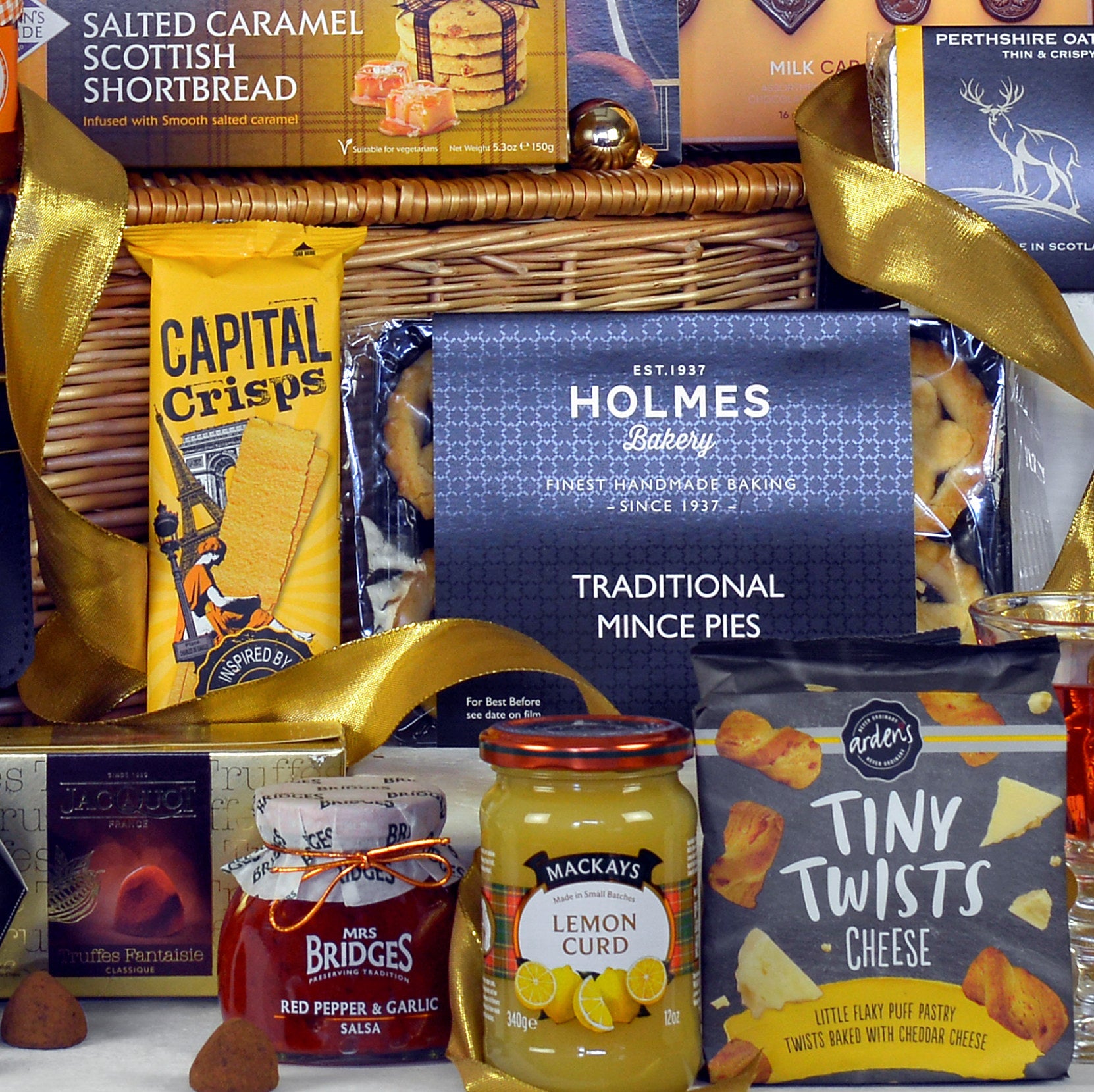 Gift basket with various items including mince pies, lemon curd, shortbread, and cheese twists.