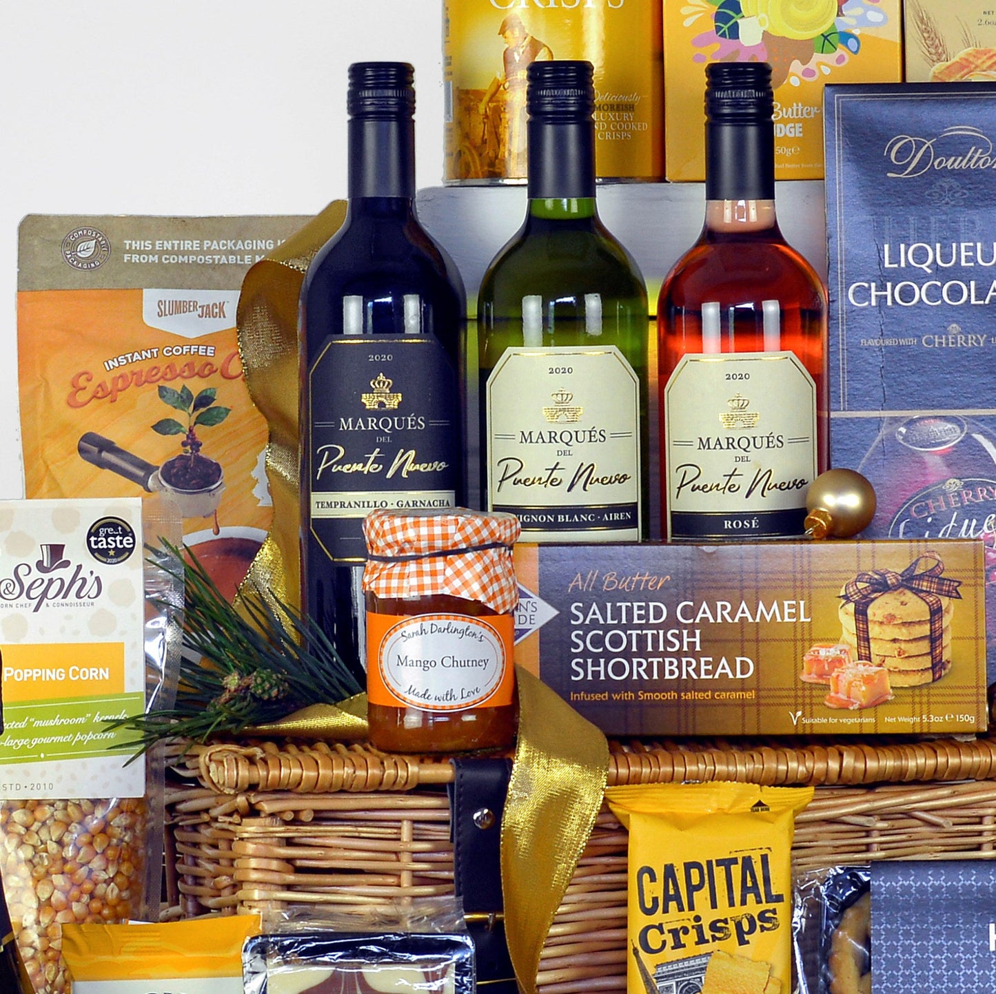 Gourmet gift basket with wine, shortbread, and other snacks.