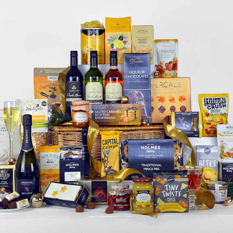 Wicker Basket with Christmas food items such as Prosecco, red, white and rose wine, mince pies, christmas pudding christmas cake, chocolate, coffee, savoury snacks and other tasty treats