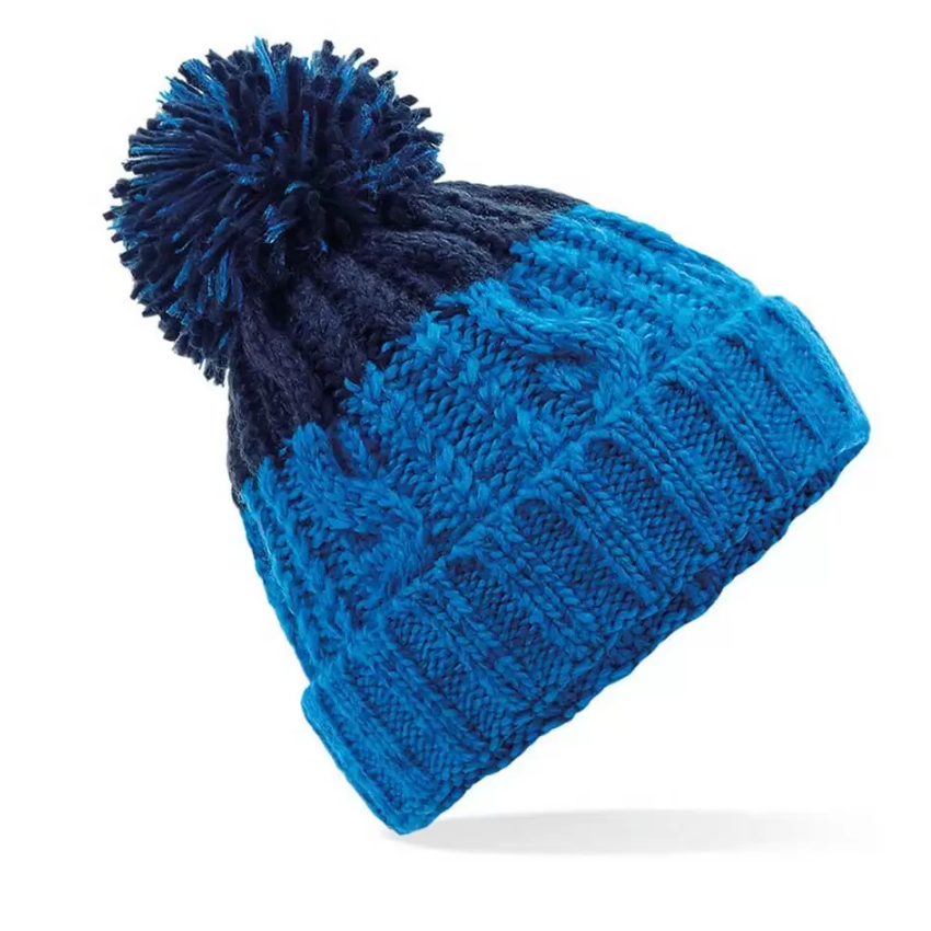 Blue knit beanie with a pom-pom on a white background