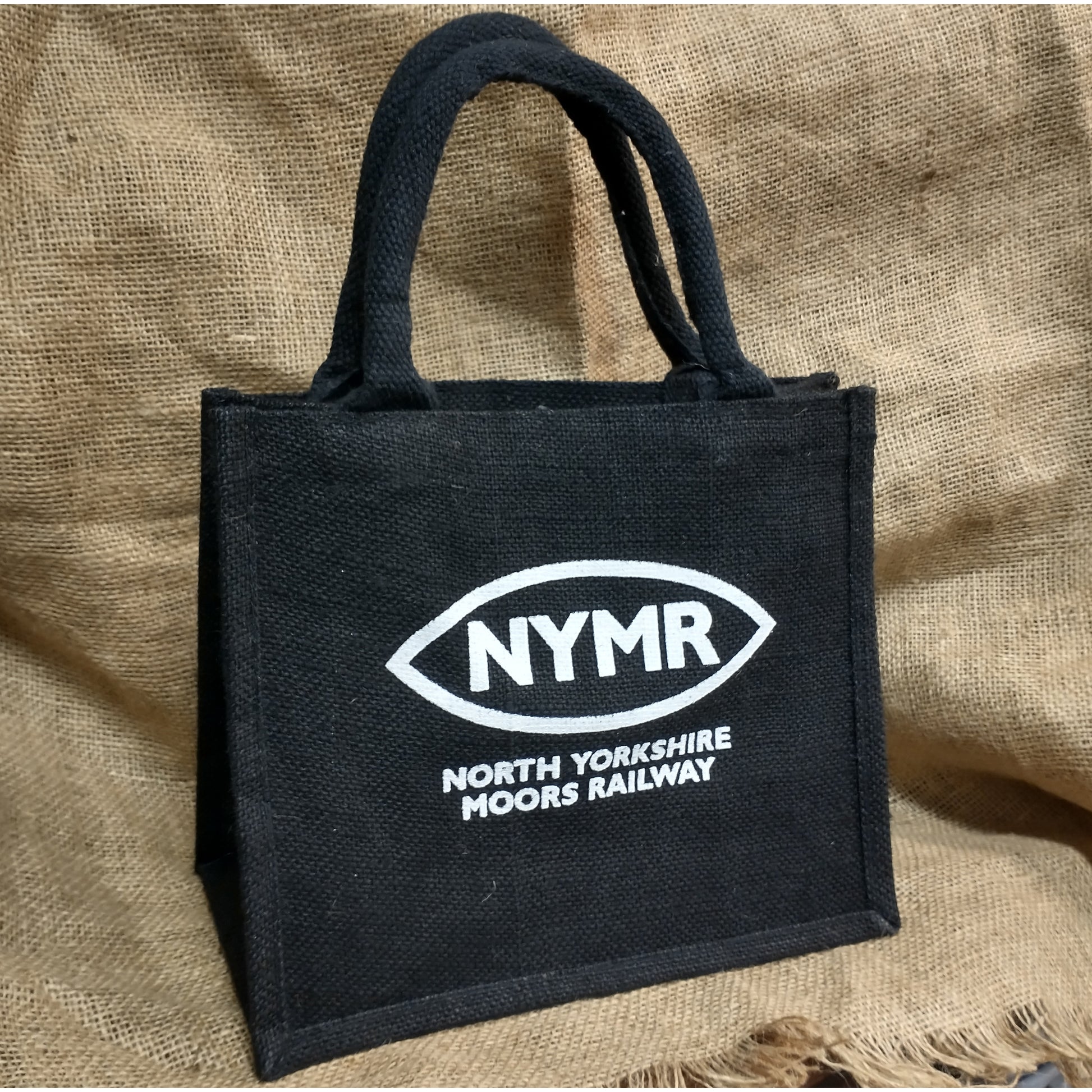 A black jute bag with the NYMR logo printed in white. Good strong handles too.