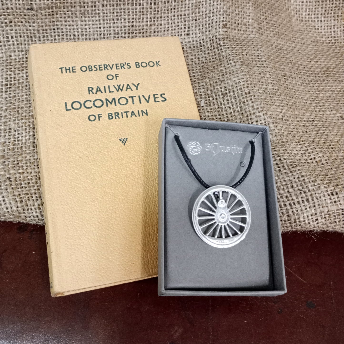 The pendant in a grey card gift box