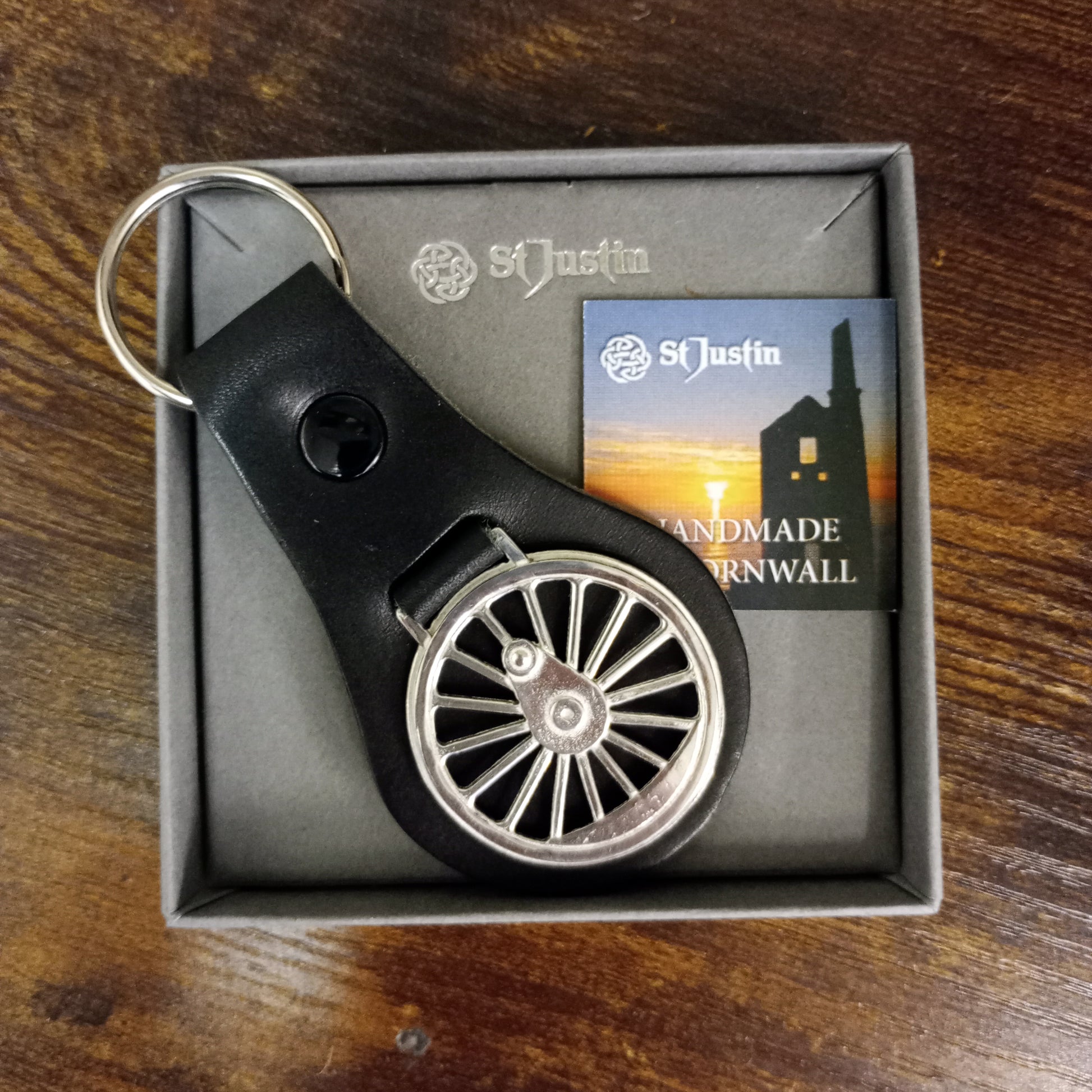 The Key fob in the grey card gift box with St Justin branding