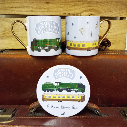 Image shows two mug together so the full design can be seen.  With green locomotive Repton and a cream and brown dining carriage. Image also shows matching round coaster.
