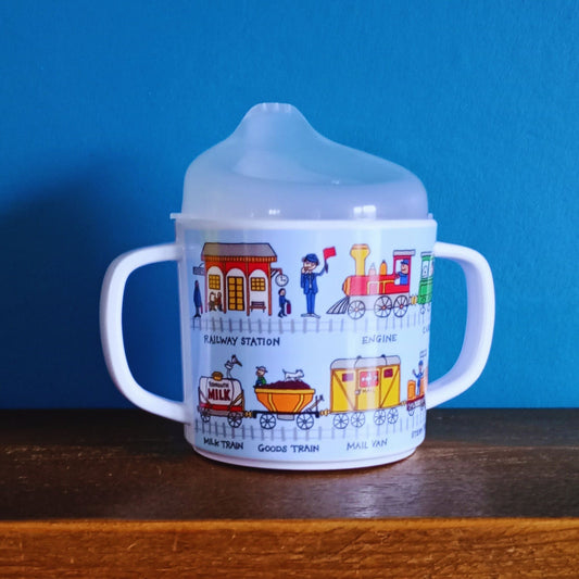 A sippy cup with super-cute trains and railway character illustrations.