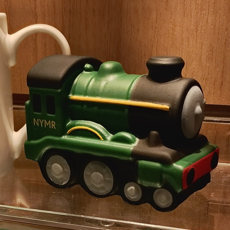 A cute squishi locomotive on a shelf