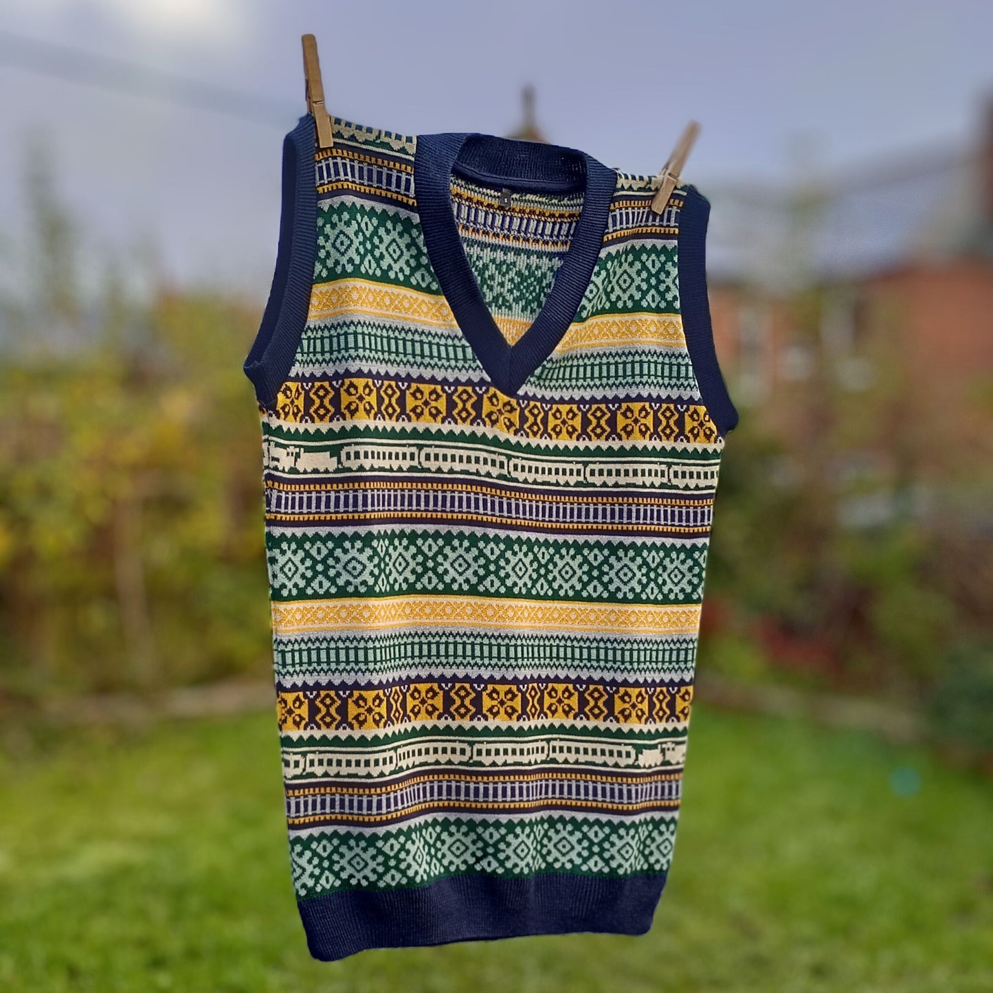 An images of the beautiful Tank Top hanging on a washing line with the garden in the background blurred so that the design pops out!