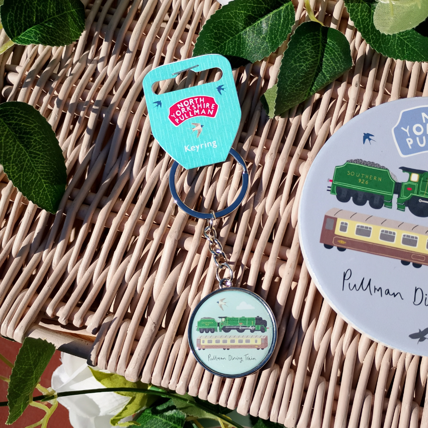 Keychain with train design on a woven surface
