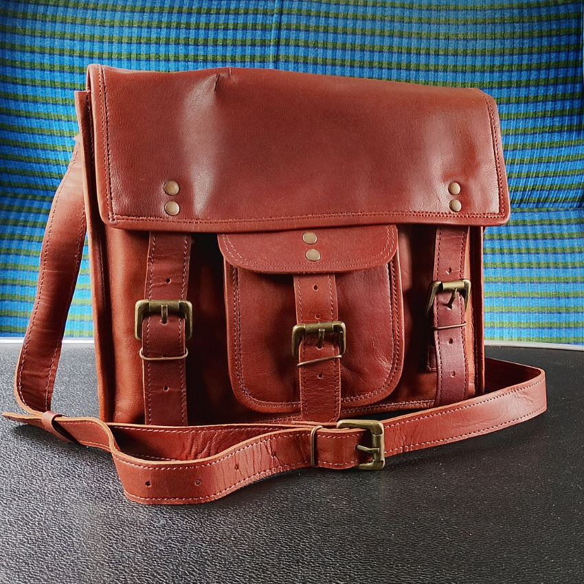A brown leather satchel in a railway carriage