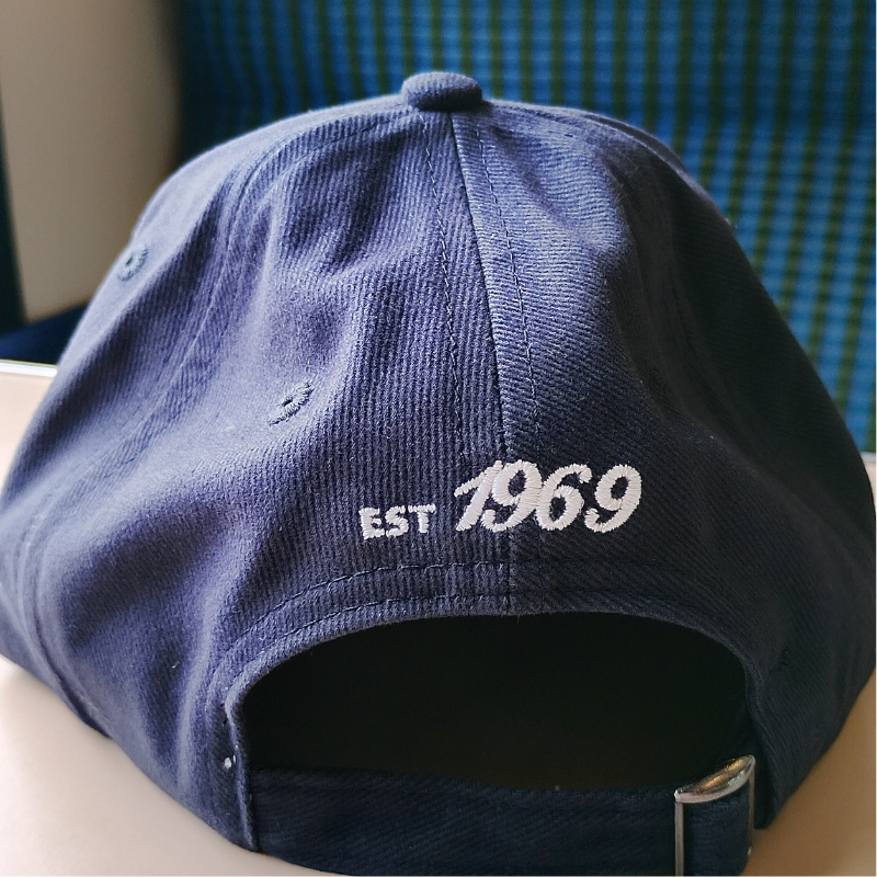 A navy blue baseball cap with 'EST 1969' embroidered in white on the back.