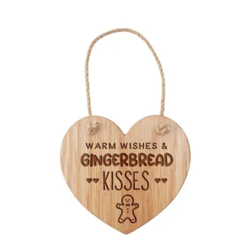 Wooden heart-shaped sign with 'Warm Wishes & Gingerbread Kisses' text and a gingerbread man illustration on a white background.