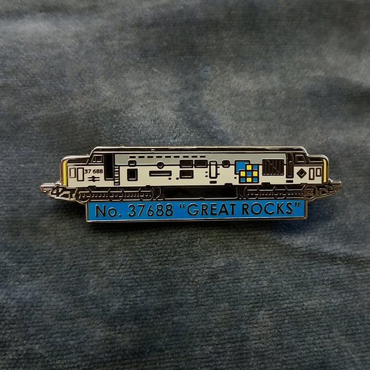 An enamel pin shaped like a locomotive train, featuring a two tone grey body with a blue section at the bottom that reads 'No. 37688 "GREAT ROCKS"' in yellow lettering.