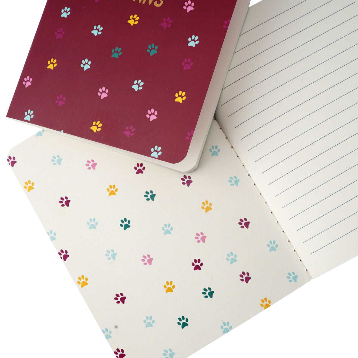 A glimpse of the insides of the notebook, showing the inside cover with a pawprint design and lines pages.
