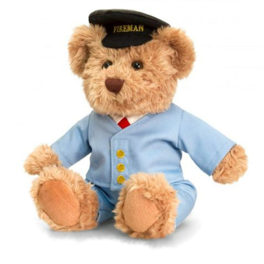 Gold coloured teddy bear in pale blue suit wearing black cap with Fireman written on peak