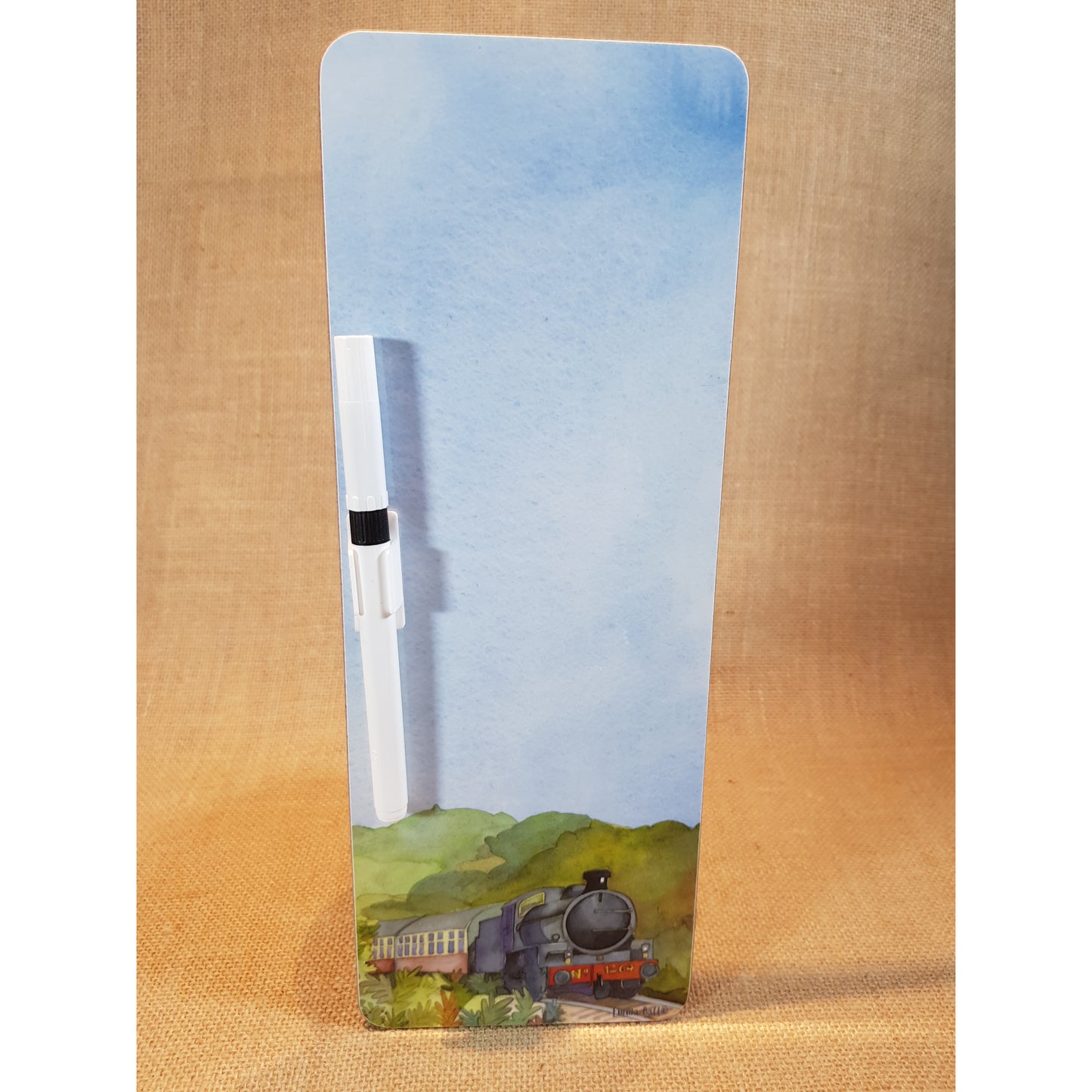 Tall narrow magnetic wipe board with painting of steam train at the bottom and lots of sky with white biro attached