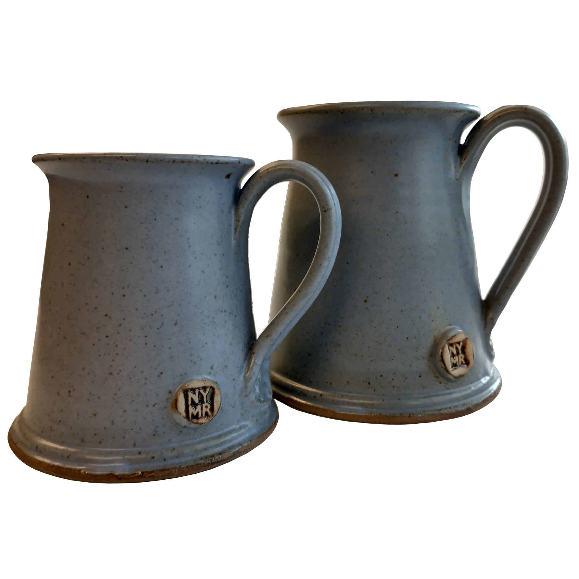 Two tankard style stoneware mugs in matt light blue with N Y M R debossed near bottom of handle.