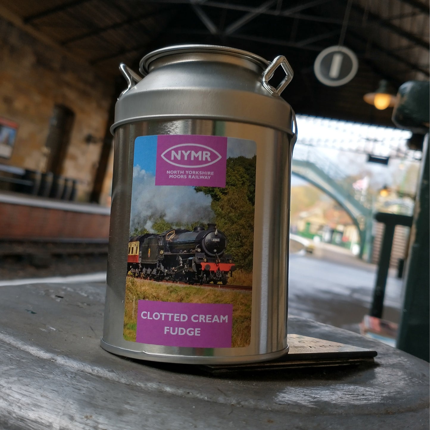 A metal fudge churn on a station platform