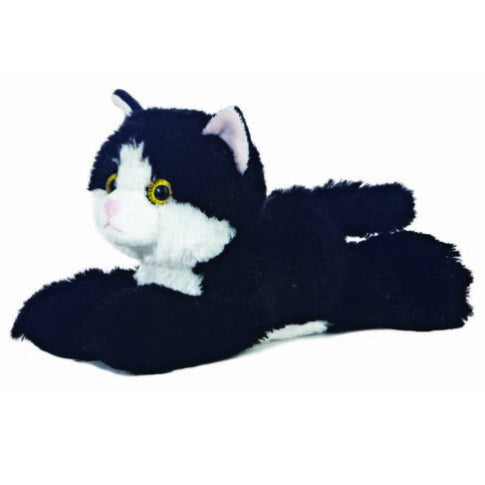 Black and white soft toy cat with green eyes.