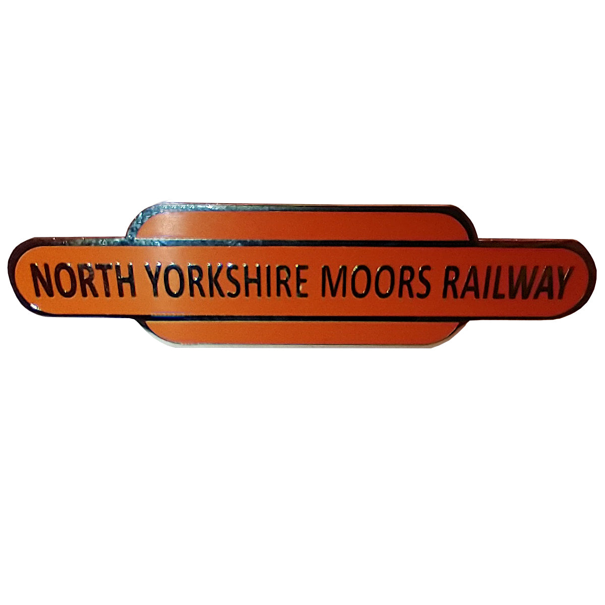 A long oblong totem shaped brooch on orange enamel and silver coloured metal which marks out the edges and the text NORTH YORKSHIRE MOORS RAILWAY